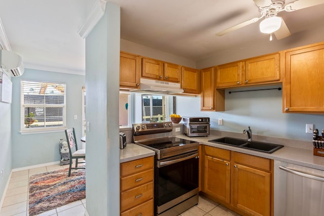 kitchen with a sink, light countertops, under cabinet range hood, a wall mounted air conditioner, and appliances with stainless steel finishes