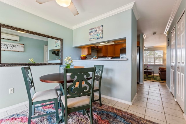 dining area featuring baseboards, a wall unit AC, ornamental molding, light tile patterned floors, and a ceiling fan