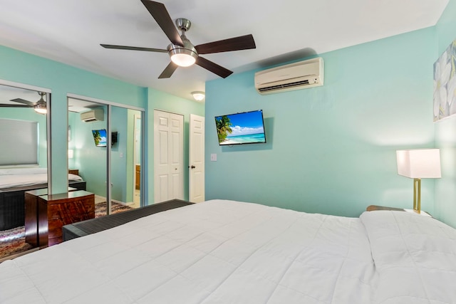 bedroom featuring ceiling fan, two closets, and a wall mounted AC