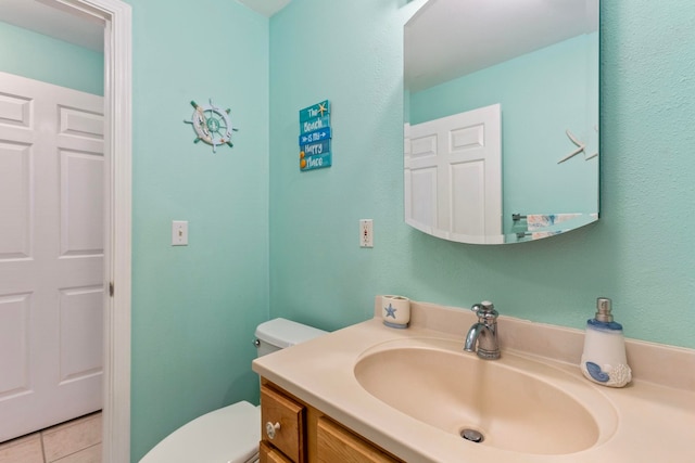 bathroom with tile patterned floors, toilet, and vanity