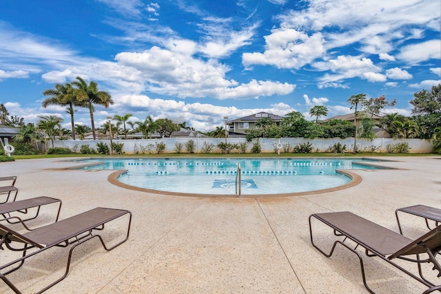 view of pool featuring a fenced in pool, fence, and a patio area