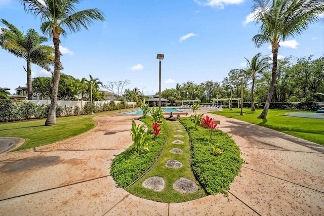 view of home's community featuring a yard and a pool