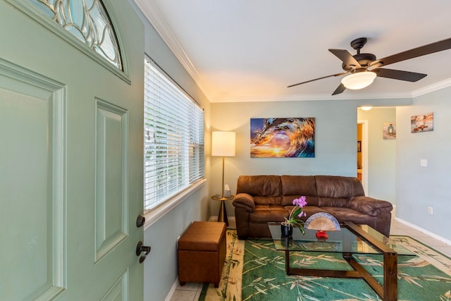 living area featuring ceiling fan, light tile patterned floors, and ornamental molding