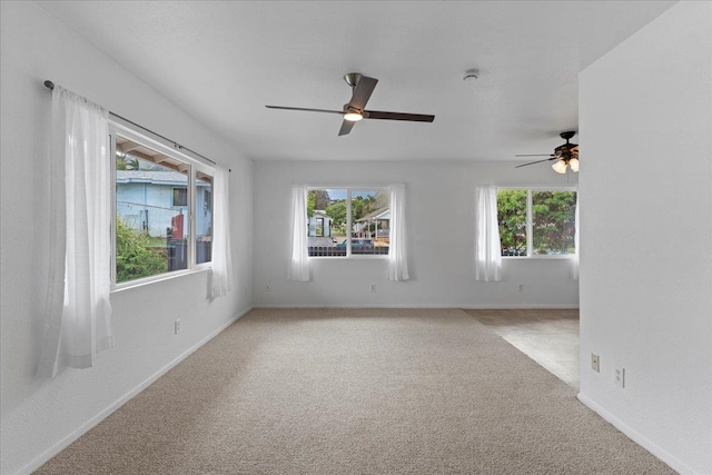 carpeted empty room featuring ceiling fan