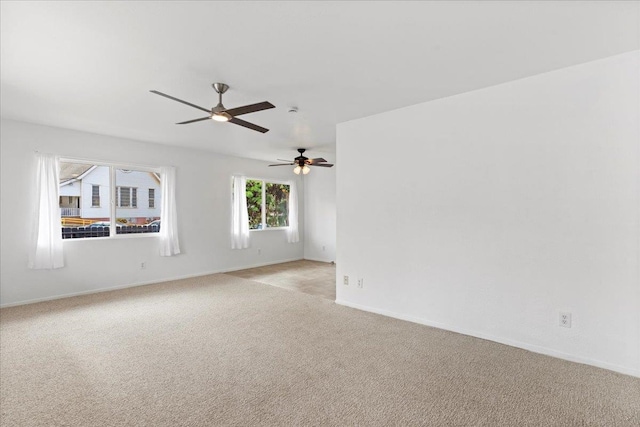 carpeted spare room with ceiling fan