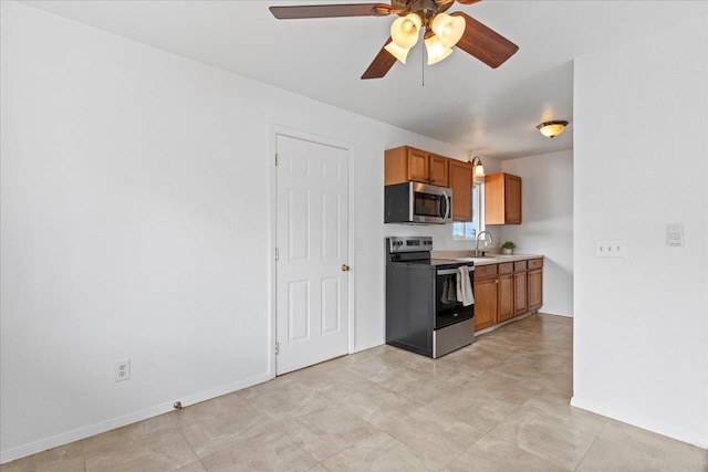 kitchen with ceiling fan and appliances with stainless steel finishes