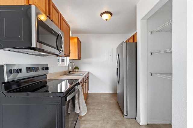 kitchen featuring sink, appliances with stainless steel finishes, and light tile patterned flooring