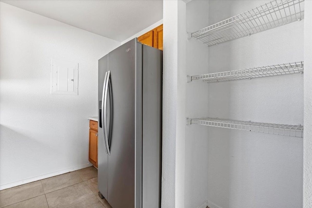 kitchen with stainless steel fridge with ice dispenser and light tile patterned floors