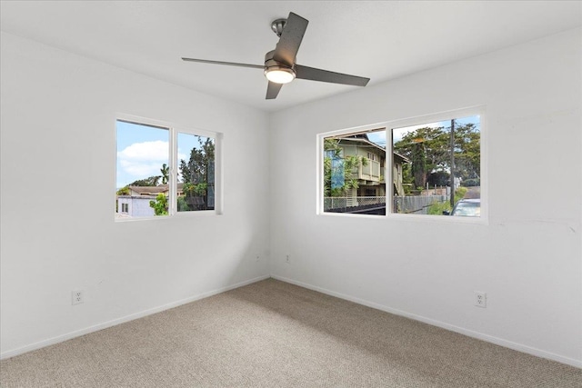 carpeted empty room featuring ceiling fan