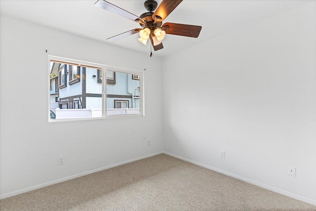 carpeted spare room featuring ceiling fan