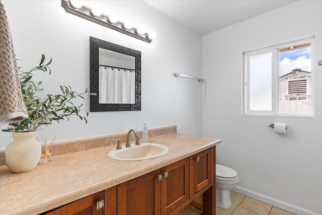 bathroom with tile patterned floors, toilet, and vanity