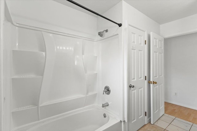 bathroom featuring hardwood / wood-style floors and tub / shower combination