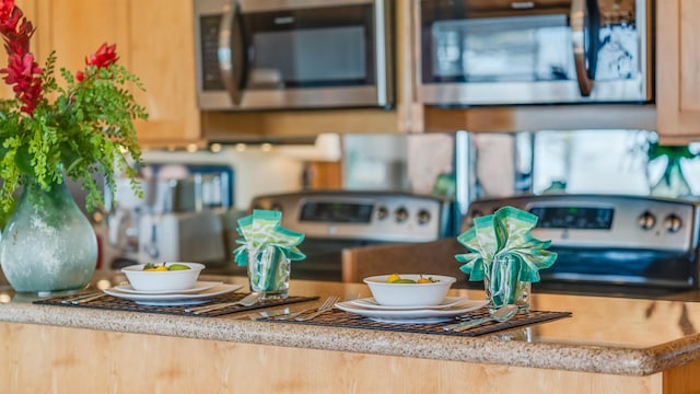 room details with light brown cabinetry and range