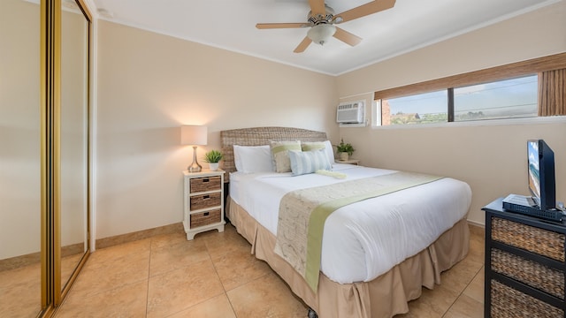 tiled bedroom with ceiling fan, an AC wall unit, ornamental molding, and a closet