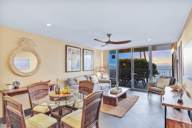 tiled living room featuring a wall of windows, recessed lighting, and a ceiling fan