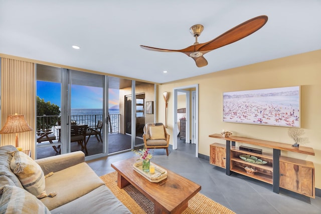 tiled living area featuring recessed lighting, baseboards, floor to ceiling windows, and a ceiling fan