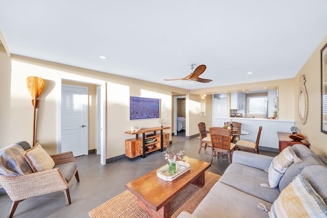 living room with tile patterned flooring, recessed lighting, baseboards, and a ceiling fan