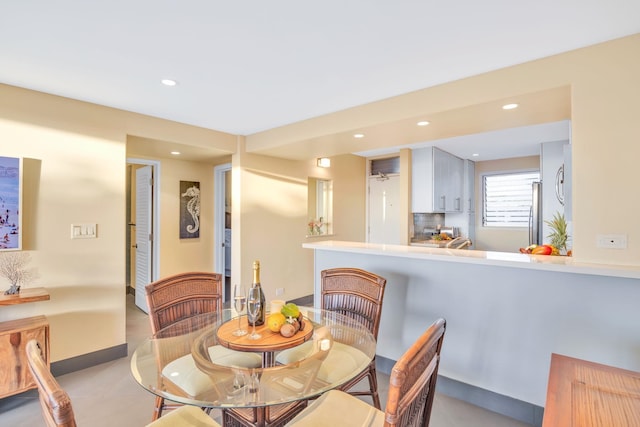 dining room featuring recessed lighting and baseboards