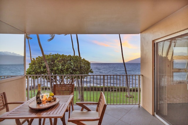 sunroom / solarium featuring a water view