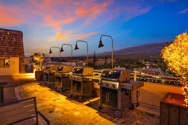 view of patio / terrace with a grill, a mountain view, and exterior kitchen