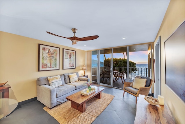 tiled living area with recessed lighting, baseboards, a wall of windows, and ceiling fan