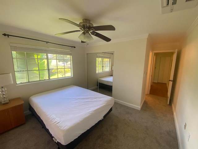 carpeted bedroom with crown molding and ceiling fan