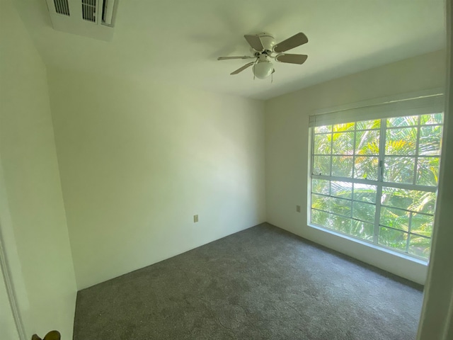 carpeted spare room featuring ceiling fan