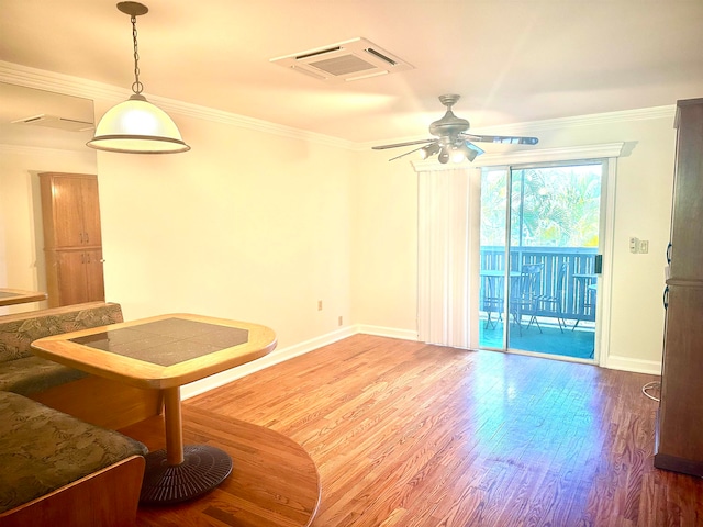 interior space featuring ornamental molding, wood-type flooring, and ceiling fan