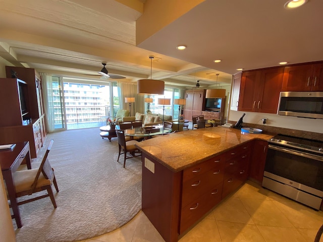 kitchen featuring light tile patterned floors, kitchen peninsula, ceiling fan, hanging light fixtures, and appliances with stainless steel finishes