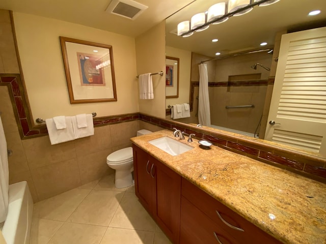 full bathroom with tile patterned flooring, toilet, tile walls, tasteful backsplash, and vanity