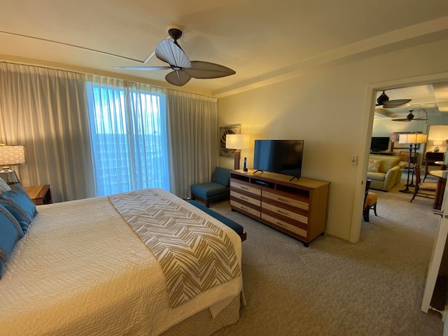 carpeted bedroom with ceiling fan and ornamental molding