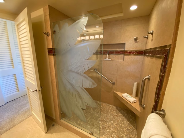 bathroom with tile walls, walk in shower, and tile patterned floors