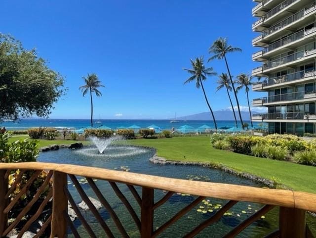 view of community featuring a water view and a yard