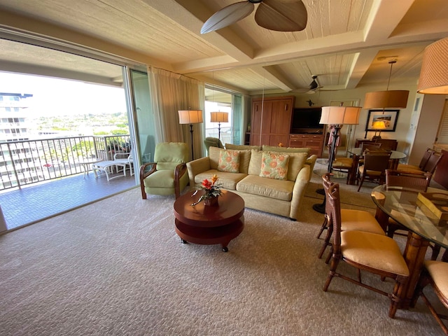 carpeted living room with beamed ceiling, coffered ceiling, ceiling fan, and wooden walls