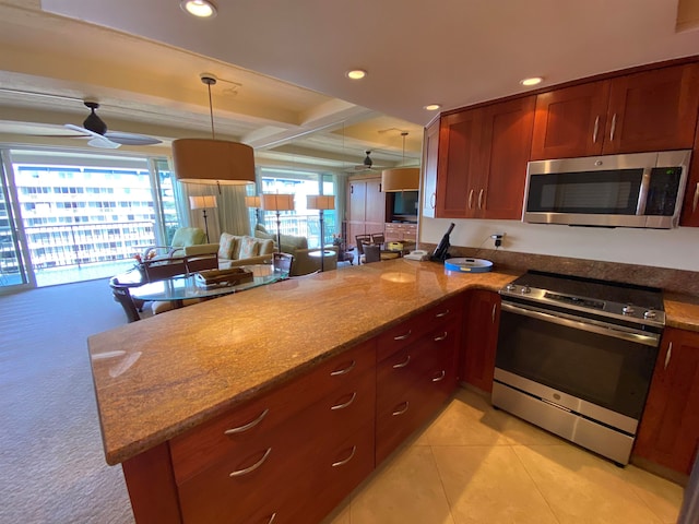 kitchen featuring kitchen peninsula, stainless steel appliances, ceiling fan, and decorative light fixtures