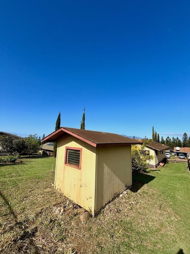 view of side of property with a yard