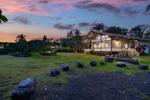 140 Waikoloa Rd, Hana, HI 96713 - yard at dusk featuring a sunroom and a yard