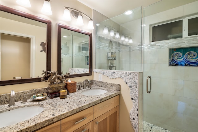 bathroom with vanity and a shower with shower door