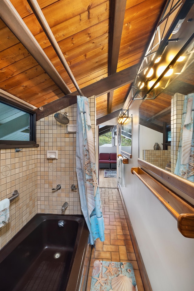 bathroom featuring beamed ceiling, shower / bathtub combination with curtain, tile walls, and wood ceiling