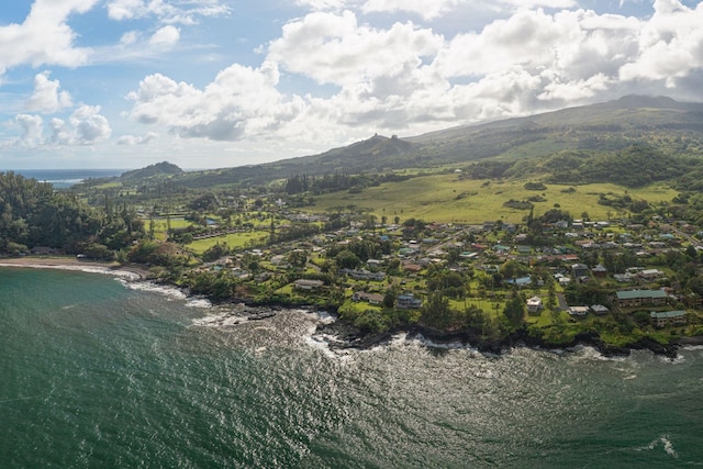 drone / aerial view with a water and mountain view