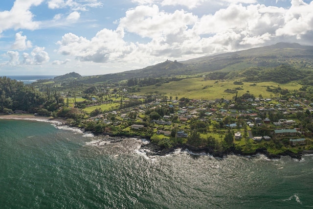 birds eye view of property with a water and mountain view