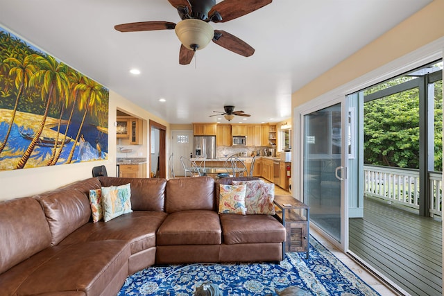 living room featuring ceiling fan and wood-type flooring