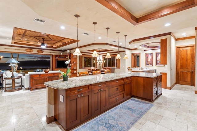 85 Lau Awa Pl, Lahaina, HI 96761 - kitchen featuring a tray ceiling, open floor plan, ornamental molding, light stone counters, and pendant lighting