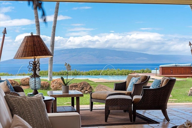 view of patio with a water and mountain view