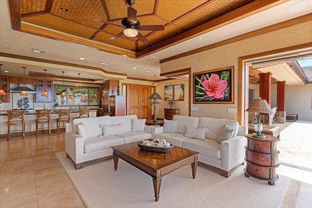 tiled living room featuring a tray ceiling and ceiling fan