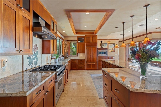 85 Lau Awa Pl, Lahaina, HI 96761 - kitchen with built in appliances, brown cabinetry, exhaust hood, a tray ceiling, and stone tile flooring