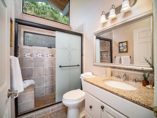 bathroom featuring tile patterned flooring, toilet, vanity, a shower with shower door, and lofted ceiling