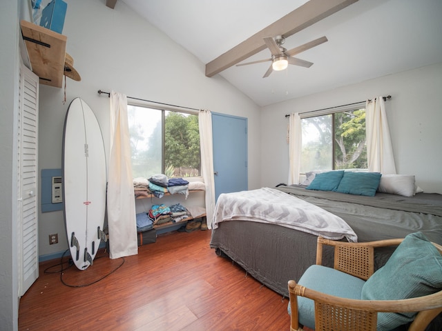 bedroom with ceiling fan, vaulted ceiling with beams, and multiple windows