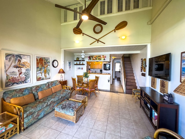 tiled living room featuring a high ceiling and ceiling fan