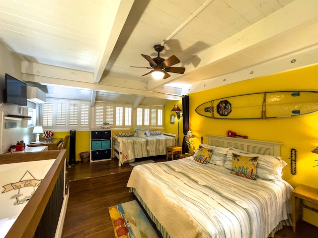 bedroom with dark hardwood / wood-style floors, beam ceiling, multiple windows, and ceiling fan